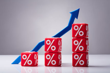 Stacked red cubes with percentage symbol in front of blue arrow going up.