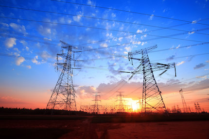 Power pylons silhouetted against the evening sky.