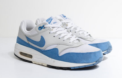 A pair of Nike Air Max Retros in light blue in front of a white background.