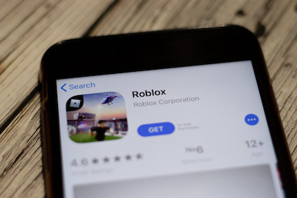 Roblox icon on App Store page close up top view on phone screen
