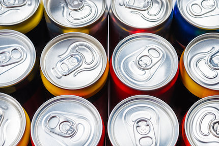 Top view of aluminum soda cans with pop tops.
