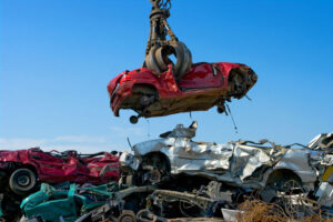 Crane picking up a car in a junkyard