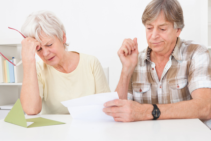 Senior couple disappointed while reading letter