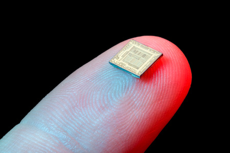 Silicon microchip on a person's finger tip