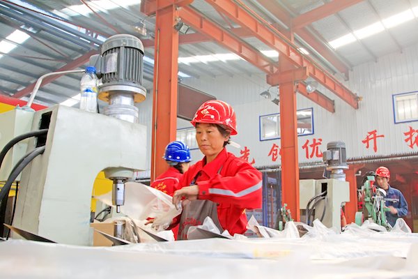 Woman working in a factory in China.