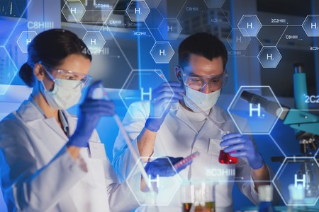 53495778 - science, chemistry, biology, medicine and people concept - close up of young scientists with pipette and flasks making test or research in clinical laboratory over hydrogen chemical formula