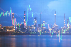 Oil refinery and oil production line graph in candlestick on blurred background