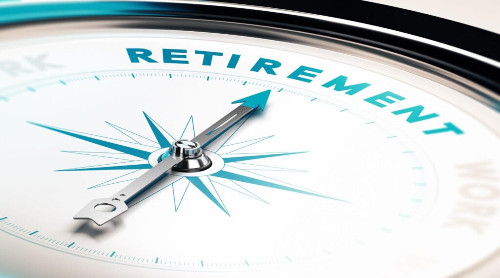 best investments for retirement: Close up shot of a compass pointing to the word retirement