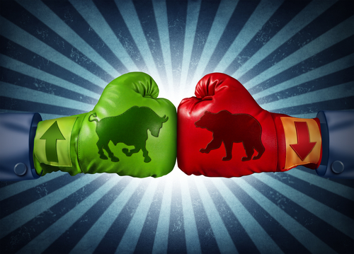 Stock market bull versus bear superimposed on boxing gloves