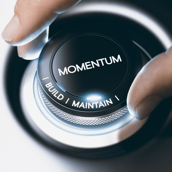 Hand turning a knob labelled "momentum"