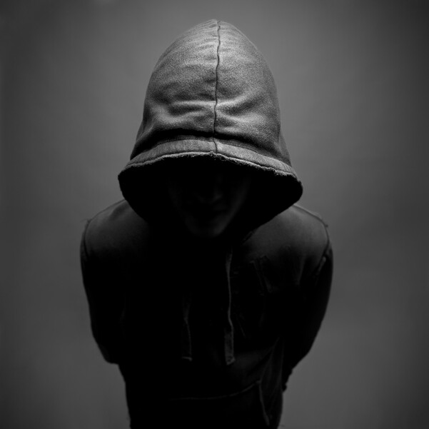 Mysterious person shadowed in hoodie