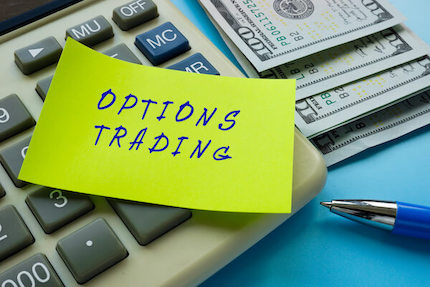 Options trading written on sticky note on calulator