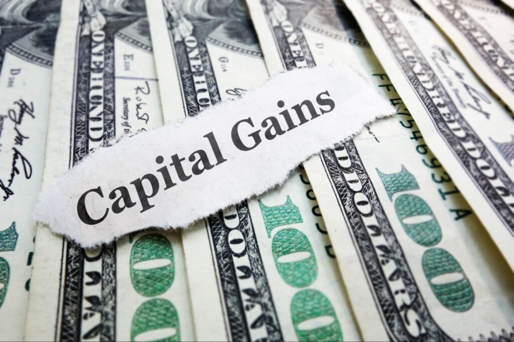 capital gains yield: dollars with a piece of paper saying capital gains