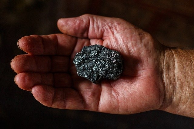 Sample of coal in a man’s hand