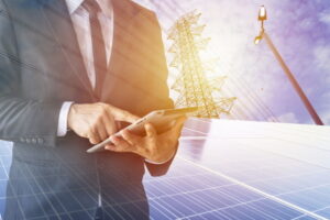 Businessmen calculate investment, breakeven, losses, finances, renewable energy, men wear a black suit, work with a computer. Internet, modern, solar cell.