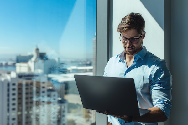 Entrepreneur using a laptop while standing