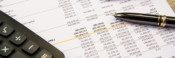 Financial statement, pen and calculator