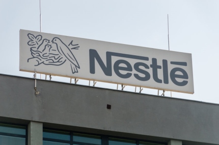 Image of sign above building showing Nestle logo and name.