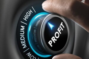 Man fingers setting profit button on highest position. Concept image for illustration of profitability or return on investment