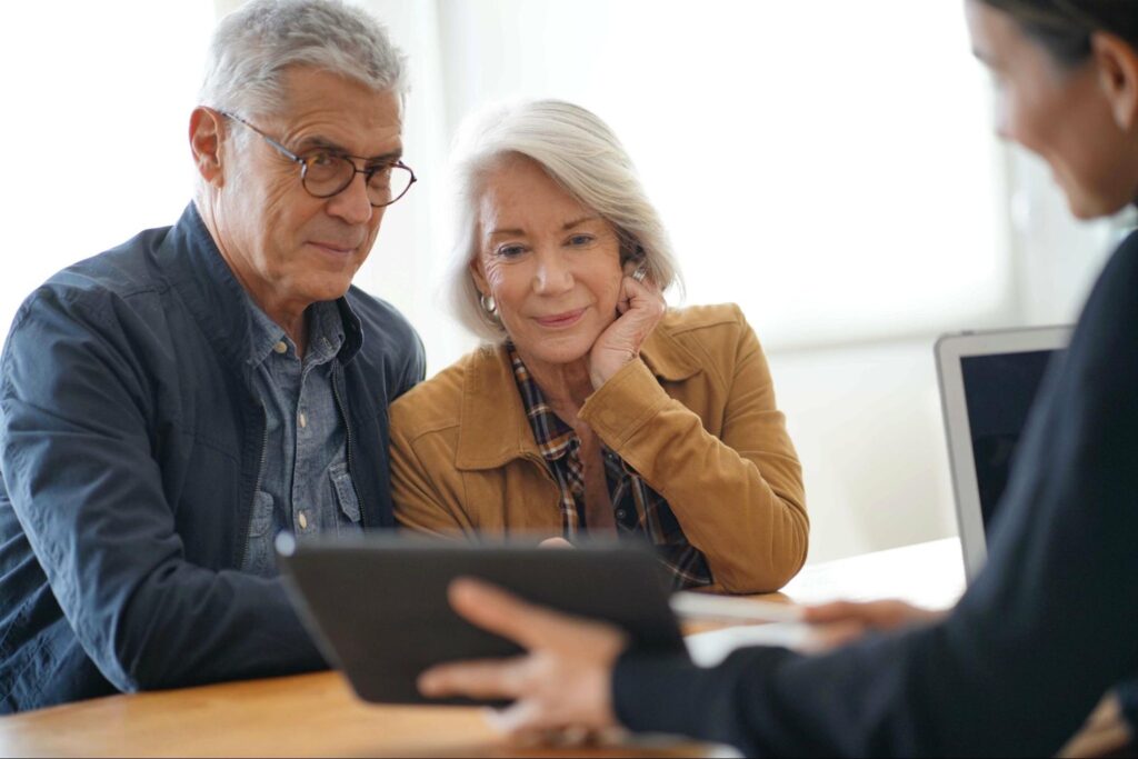 how to trade options: old man and woman looking at the tablet