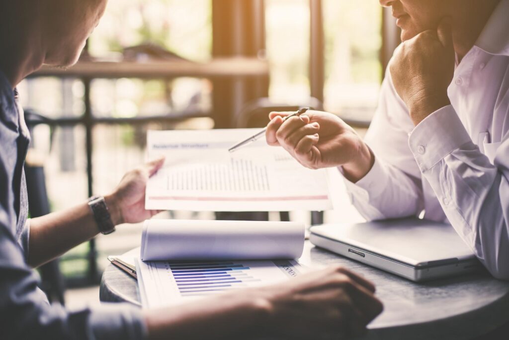 Two people discussing a report