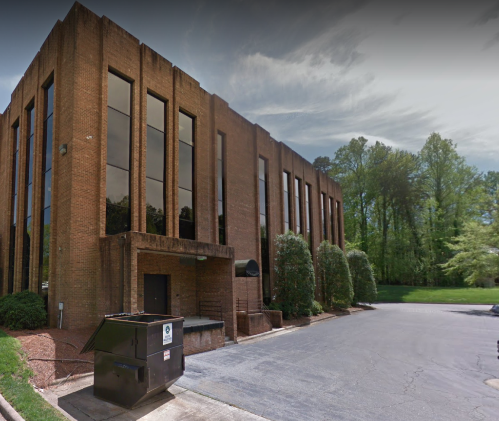 Picture of a brown brick office building.