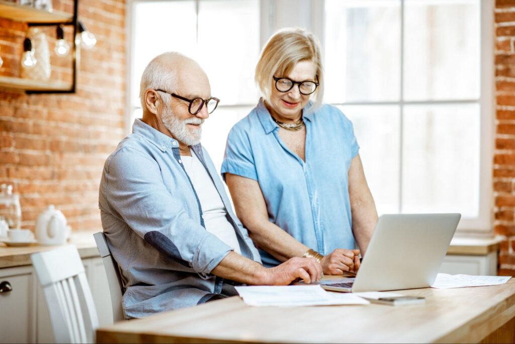 best long term dividend stocks: elderly couple looking at paperwork