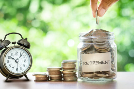 Glass jar full of coins labeled "retirement"