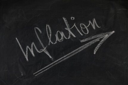 Chalkboard with the word inflation and an upward trending arrow.