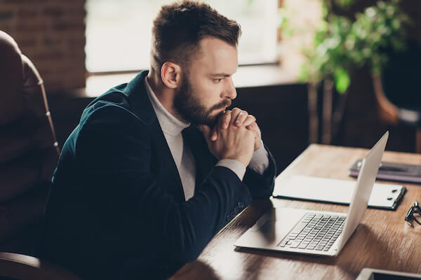 Man reading from his laptop