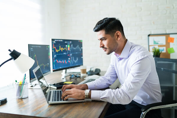 Options trader working on his laptop