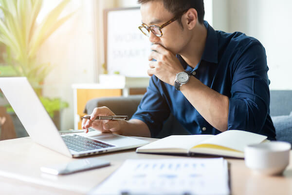 option premium: man looking at his laptop