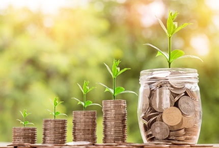 Coins in jars with small plants growing out of them.