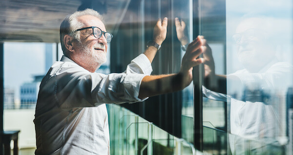 old man looking outside the building