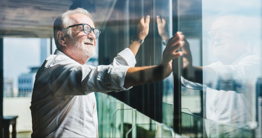 best stocks for retirement: old man staring out the window