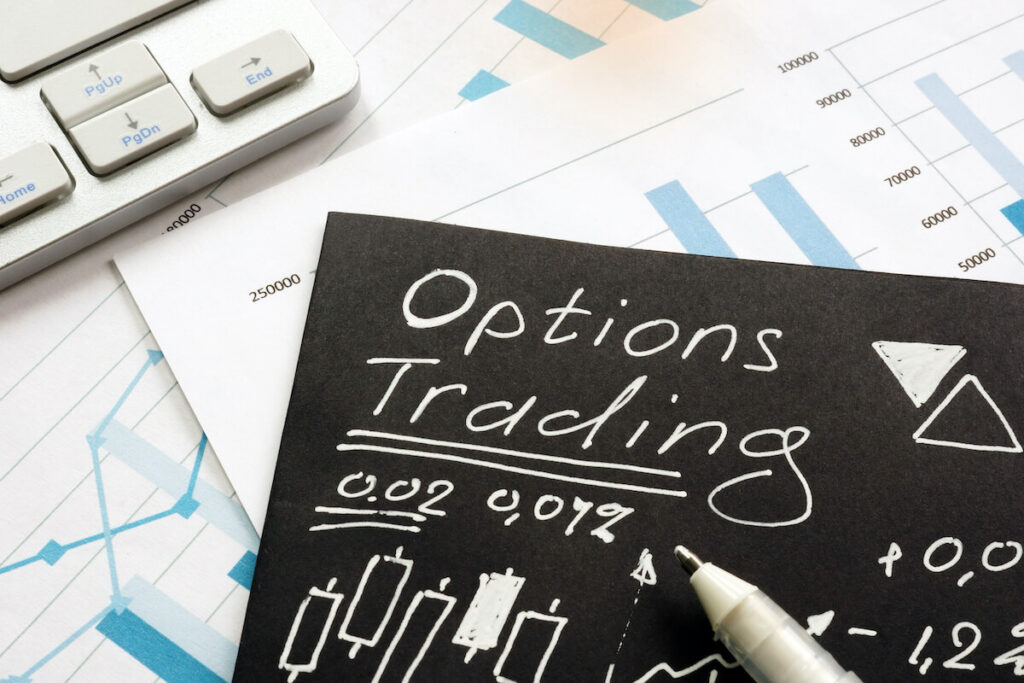 Option trading written on black piece of paper.