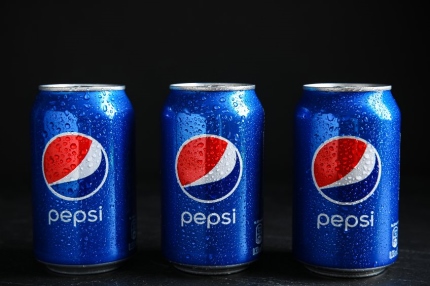 Three cans of Pespi cola soft drink