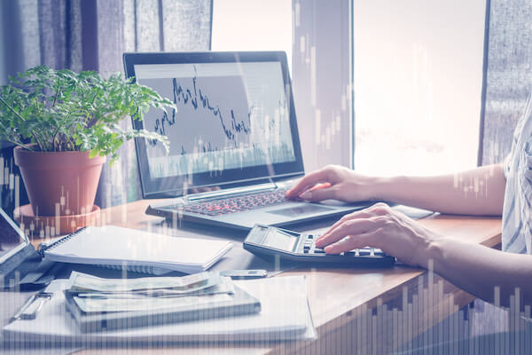 Dividend investing strategy: person checking stocks on a laptop