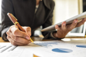 Businesswomen analyzing investment charts in meeting room, Accounting concept, soft focus, vintage tone