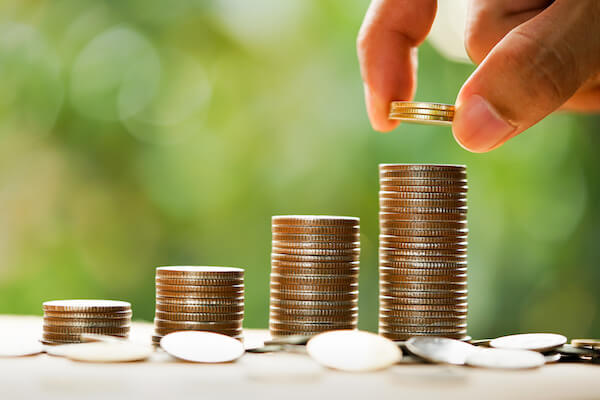 Best fixed income investments: person stacking coins