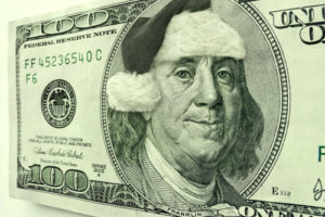 Ben Franklin is in the Christmas Spirit for the Holiday's wearing a Santa Hat and a smile, not normally seen on this Hundred Dollar Bill Portrait.