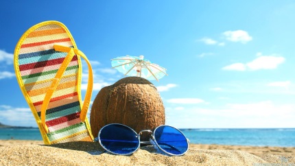 sandal and coconut chilling on a beach with glasses