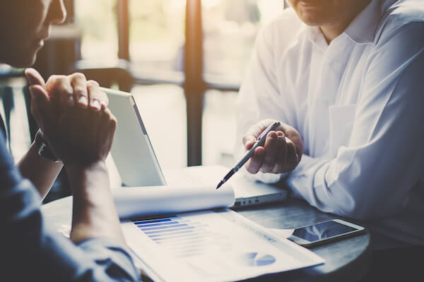 Income investing strategy: two people discussing charts